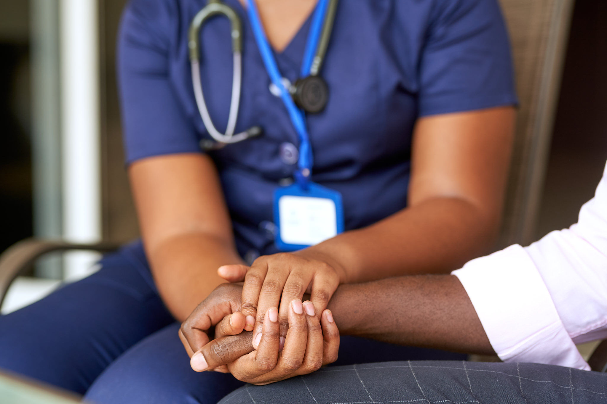 Healthcare professional comforting a patient